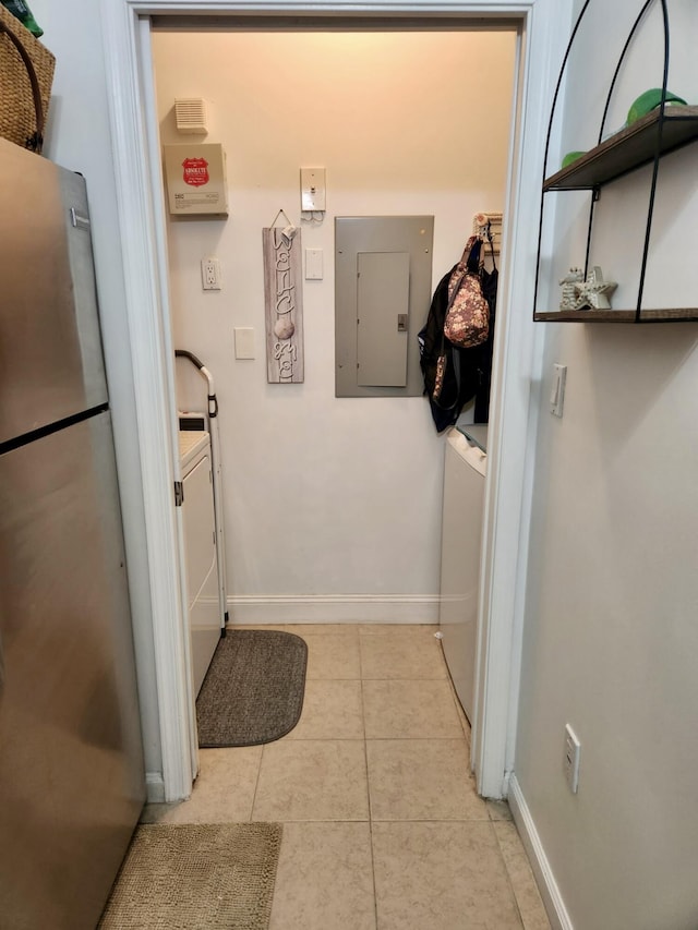 laundry room featuring light tile patterned flooring and electric panel