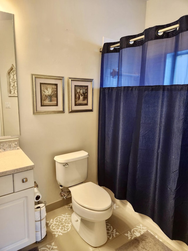 bathroom with vanity, a shower with shower curtain, and toilet