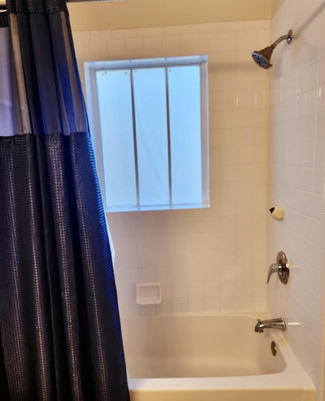 bathroom featuring shower / bathtub combination with curtain