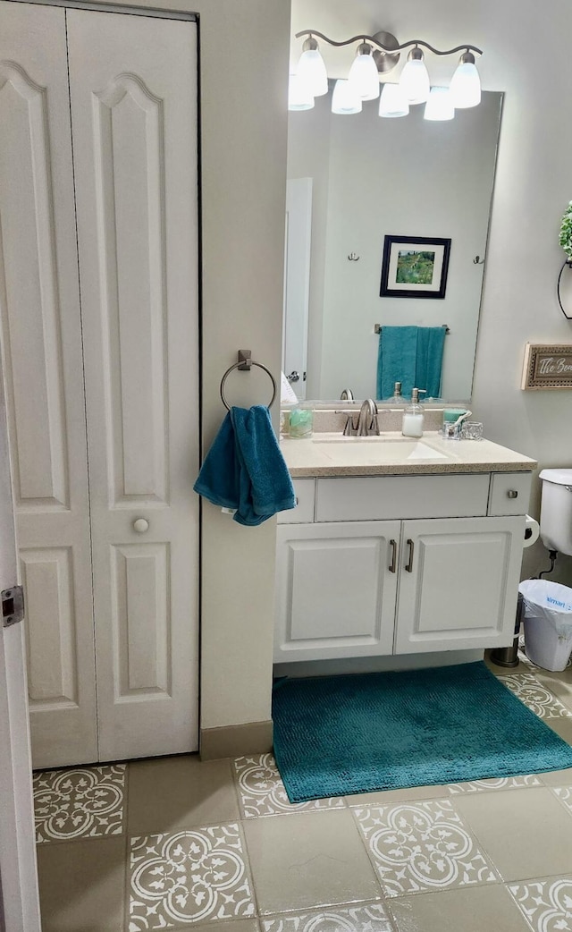 bathroom featuring vanity, tile patterned floors, and toilet