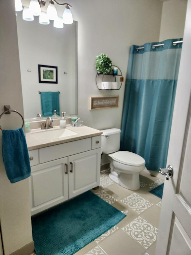 bathroom featuring vanity, toilet, tile patterned flooring, and a shower with shower curtain