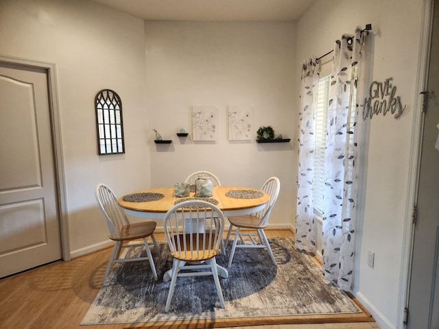 dining space featuring plenty of natural light and light hardwood / wood-style floors