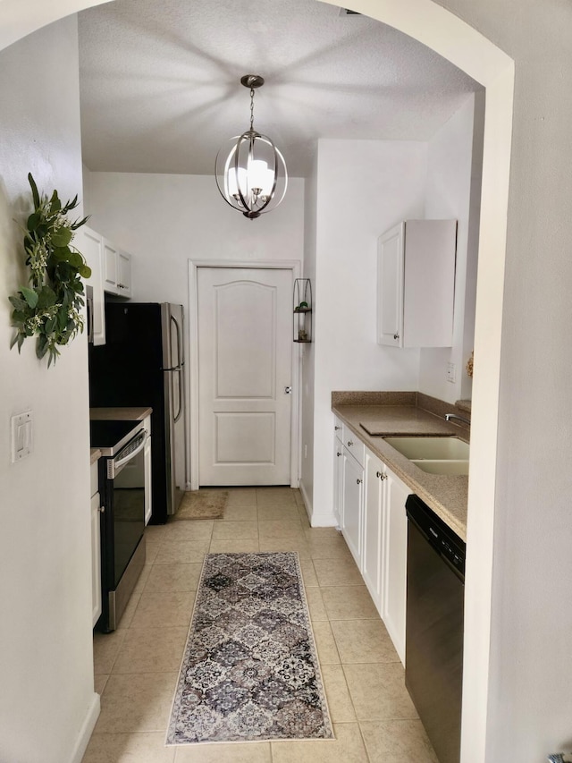 kitchen featuring stainless steel appliances, white cabinetry, sink, and pendant lighting