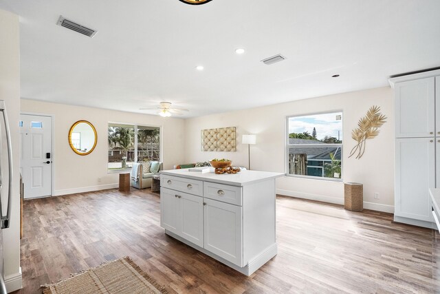 7423 SE James St, Hobe Sound, FL 33455 - unfurnished bedroom featuring a ceiling fan, visible vents, wood finished floors, baseboards, and access to outside
