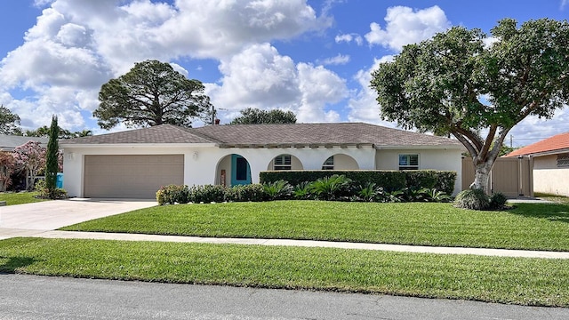 view of front of property with a garage and a front lawn