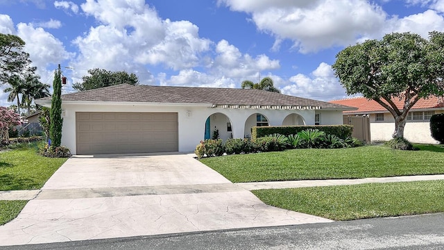 view of front of house featuring a garage and a front lawn