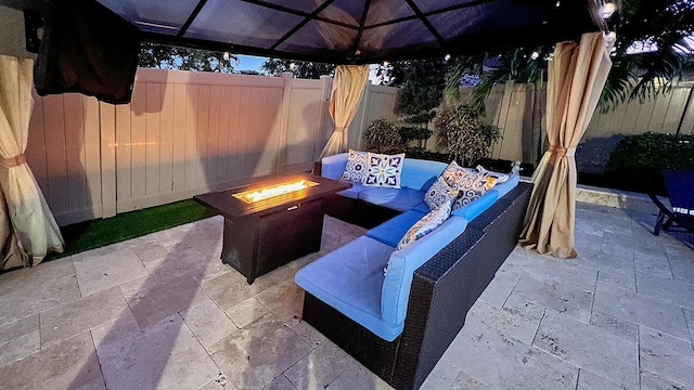 view of patio featuring an outdoor living space with a fire pit and a fenced backyard