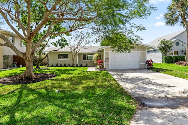 single story home featuring an attached garage, driveway, and a front yard