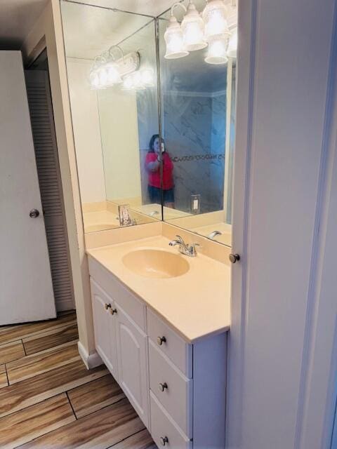 bathroom with wood finished floors and vanity