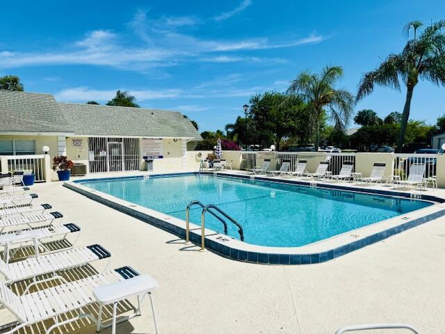 pool with fence and a patio