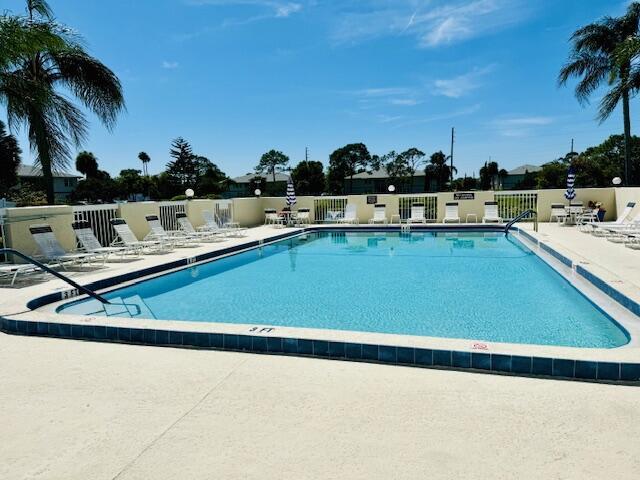 community pool featuring a patio area and fence