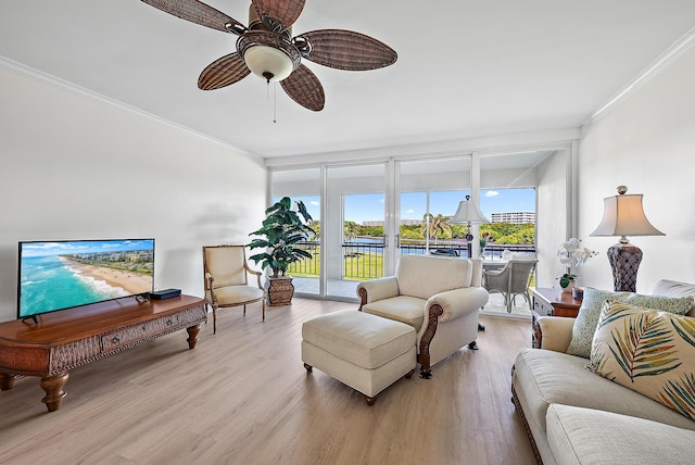 living room with ceiling fan, ornamental molding, floor to ceiling windows, and light hardwood / wood-style flooring