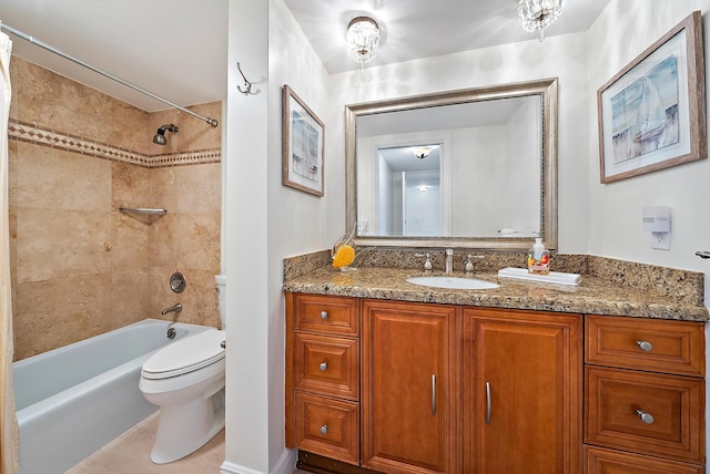 full bathroom with vanity, tiled shower / bath, and toilet