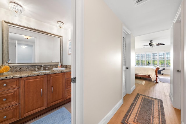 bathroom featuring hardwood / wood-style flooring, vanity, and ceiling fan