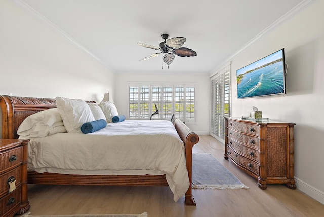 bedroom featuring ceiling fan, ornamental molding, and light hardwood / wood-style flooring