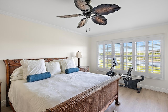 bedroom featuring crown molding, ceiling fan, and light hardwood / wood-style flooring