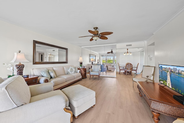 living room with ornamental molding, light wood-type flooring, and ceiling fan