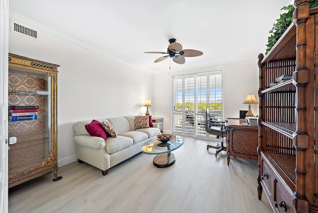 living room featuring crown molding, ceiling fan, and light hardwood / wood-style floors