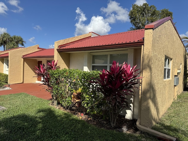 view of side of property with a yard