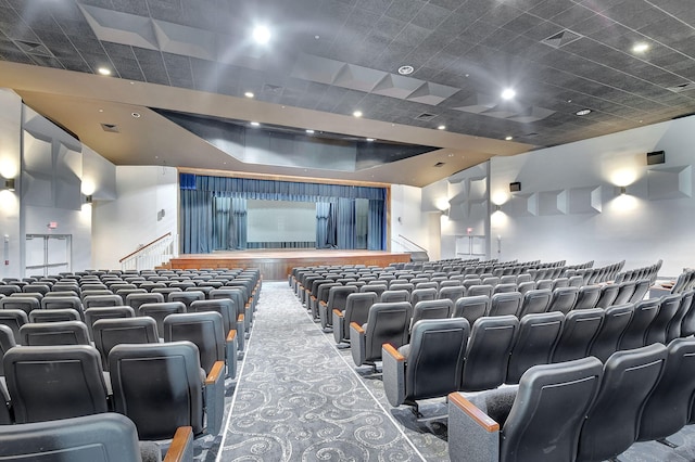 home theater featuring carpet floors and a tray ceiling