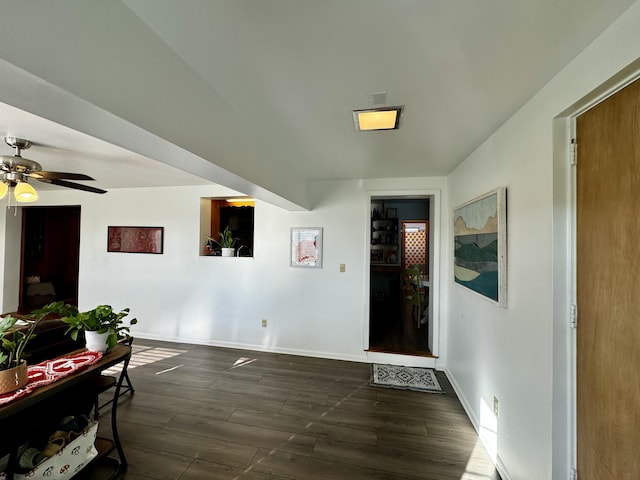 interior space with dark wood-type flooring and ceiling fan