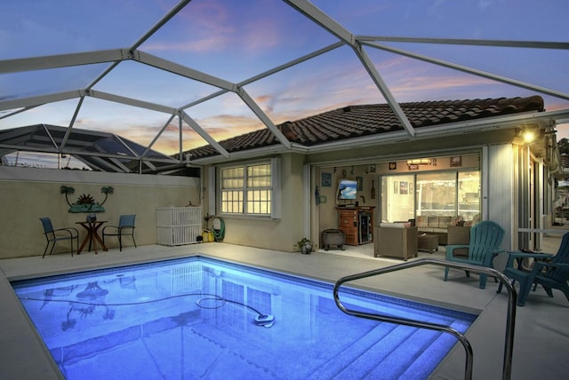 outdoor pool featuring an outdoor living space and a patio area