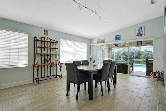 8376 SE Paurotis Ln, Hobe Sound, FL 33455 - dining area featuring visible vents, light wood-style flooring, baseboards, and vaulted ceiling