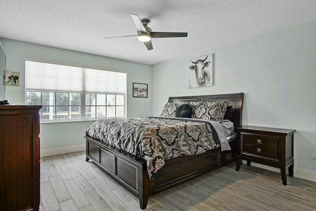 8376 SE Paurotis Ln, Hobe Sound, FL 33455 - bedroom featuring baseboards, ceiling fan, and wood tiled floor