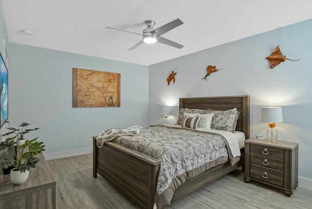 bedroom with ceiling fan and light wood-type flooring