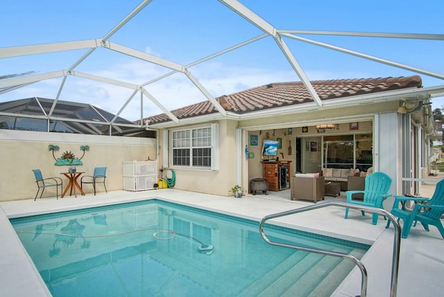 pool with outdoor lounge area, a patio, and a lanai