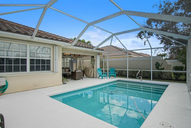 view of pool with a lanai and a patio