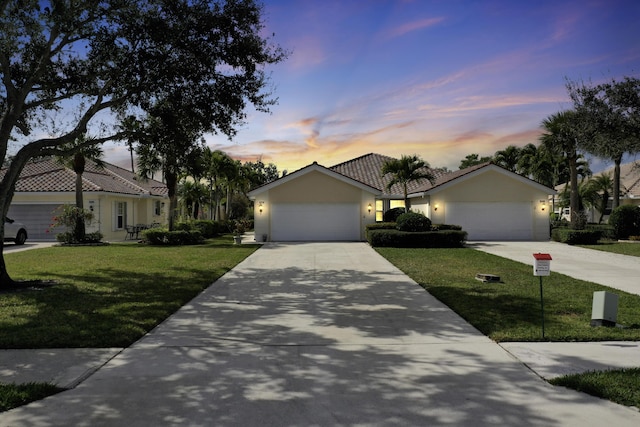 8376 SE Paurotis Ln, Hobe Sound, FL 33455 - ranch-style home featuring a tile roof, concrete driveway, a lawn, stucco siding, and a garage