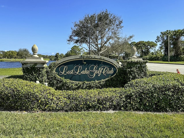 community / neighborhood sign with a water view