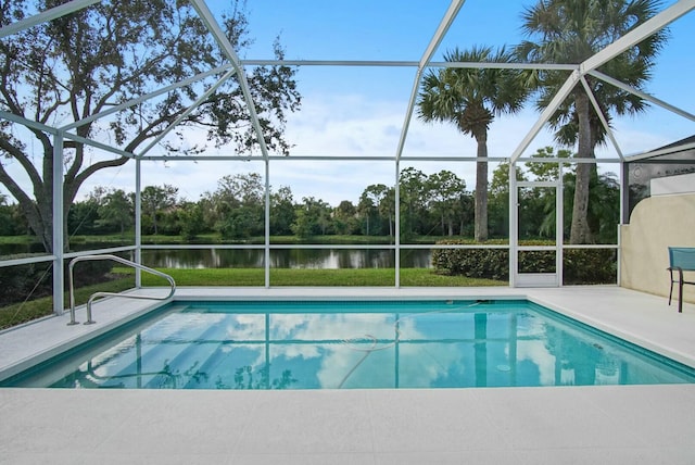 8376 SE Paurotis Ln, Hobe Sound, FL 33455 - outdoor pool featuring glass enclosure, a patio, and a water view