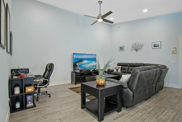 living room with ceiling fan and light wood-type flooring