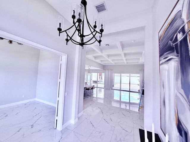 empty room featuring marble finish floor, visible vents, a chandelier, coffered ceiling, and baseboards