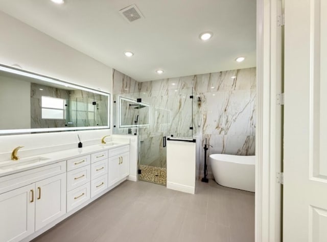 bathroom with visible vents, double vanity, recessed lighting, a sink, and a marble finish shower
