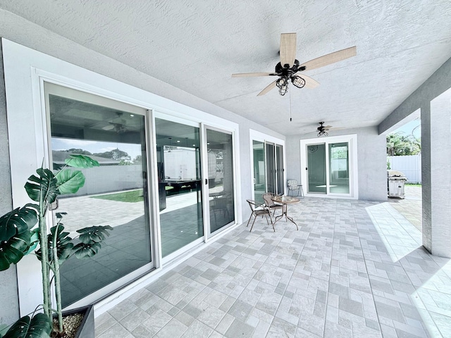 exterior space featuring a ceiling fan