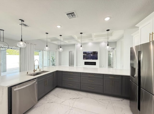 kitchen featuring light countertops, appliances with stainless steel finishes, a sink, and marble finish floor