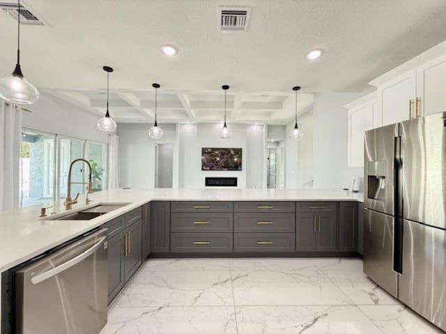kitchen featuring appliances with stainless steel finishes, a sink, light countertops, recessed lighting, and coffered ceiling