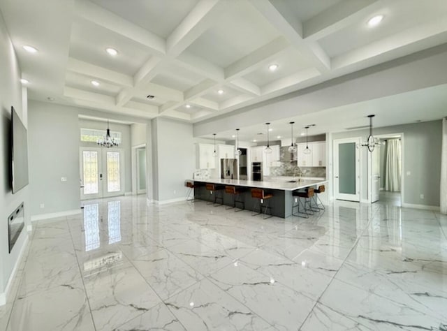 living area featuring an inviting chandelier, baseboards, french doors, and marble finish floor