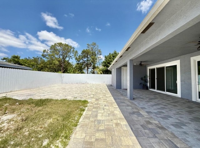 view of yard with a patio, a ceiling fan, and a fenced backyard