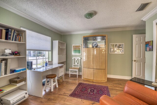 office space featuring wood-type flooring, a textured ceiling, and crown molding