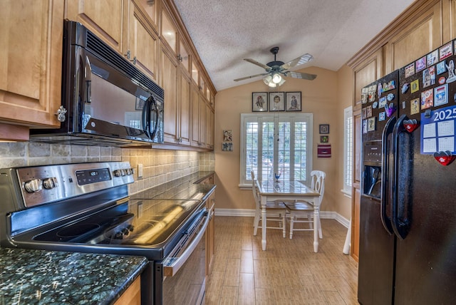 kitchen with lofted ceiling, decorative backsplash, dark stone counters, black appliances, and a textured ceiling