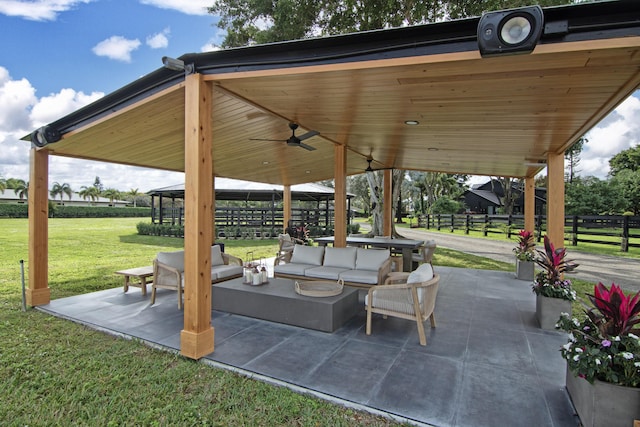 view of patio / terrace with outdoor lounge area, fence, a gazebo, and ceiling fan