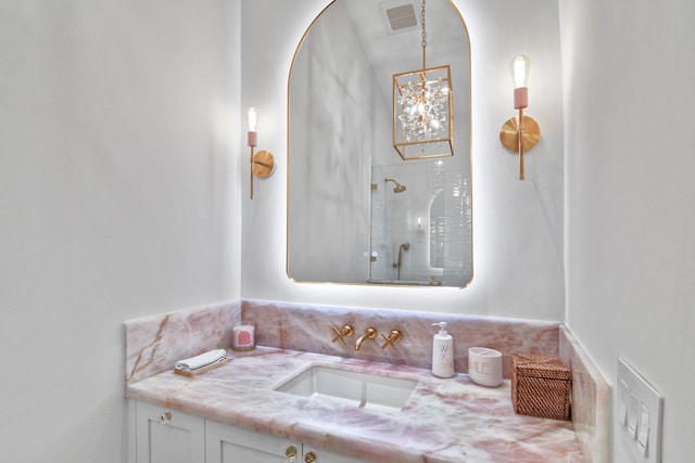 full bathroom featuring a tile shower and vanity