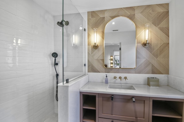 bathroom featuring visible vents, walk in shower, and vanity