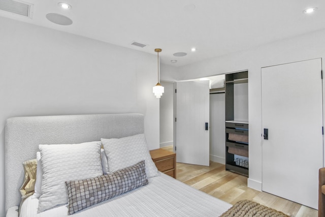 bedroom featuring light wood finished floors, visible vents, and recessed lighting