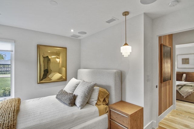 bedroom with recessed lighting, visible vents, light wood-style flooring, and baseboards