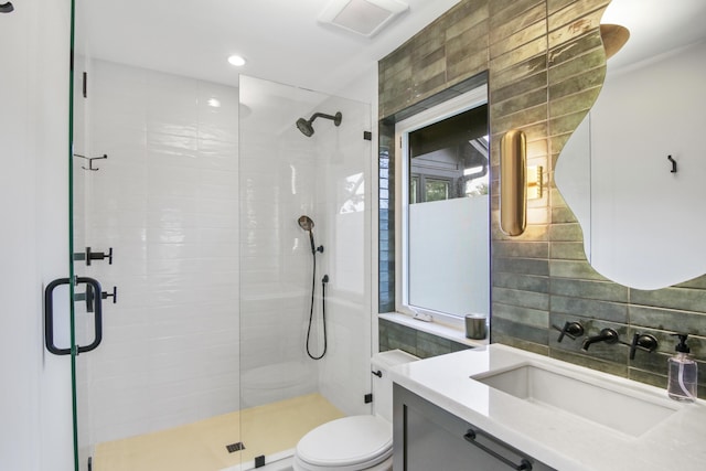 full bathroom featuring a stall shower, visible vents, toilet, vanity, and tile walls